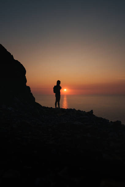 istock A hiker silhouetted against a glowing sunset over the Mediterranean in Mallorca. 2194847763