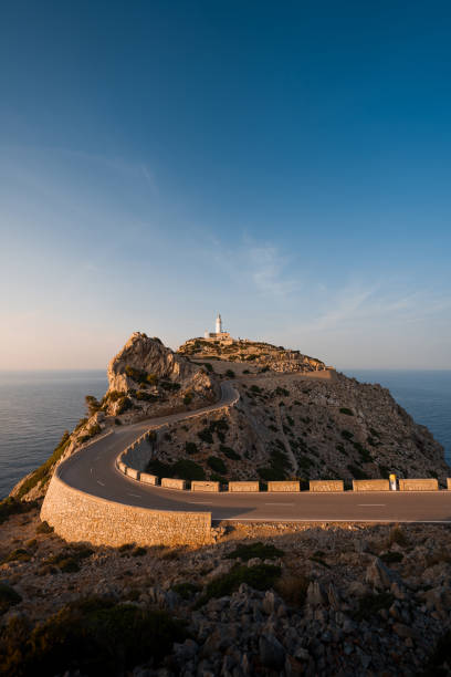 istock The road to Formentor Lighthouse winds through cliffs illuminated by the golden sunset. 2194847802