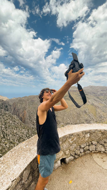 istock A traveler smiles while taking a photo amidst Mallorca's breathtaking mountain backdrop. 2194848006
