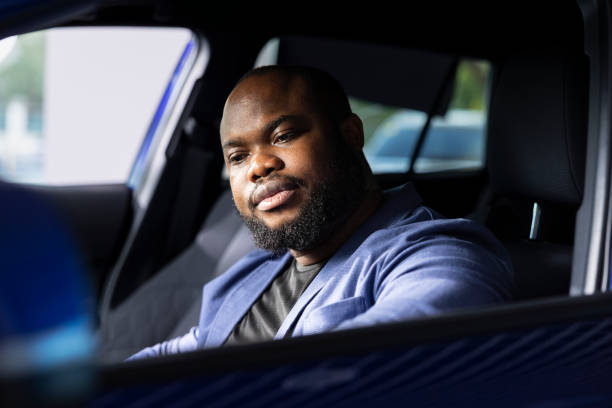 istock Man in car dealership doing test drive 2194850018