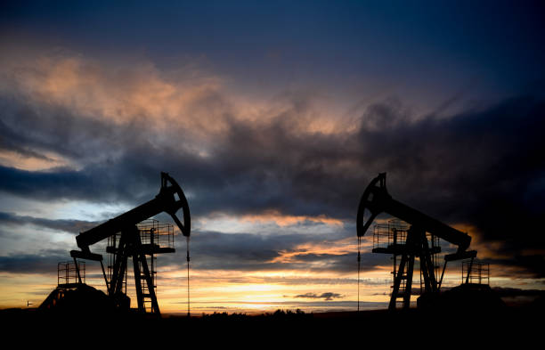 istock Oil drilling derricks at desert oilfield. 2194852842