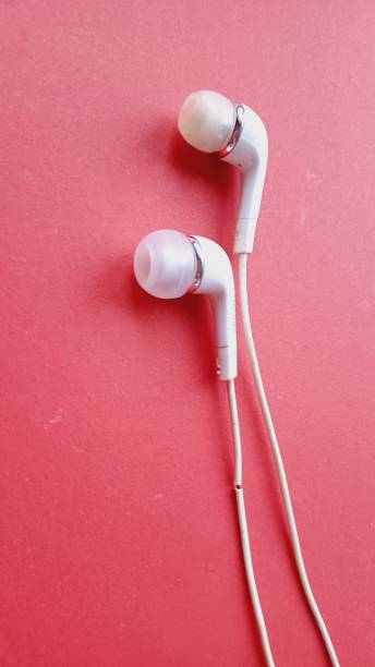 istock White telephone headset on a red background. 2194853684