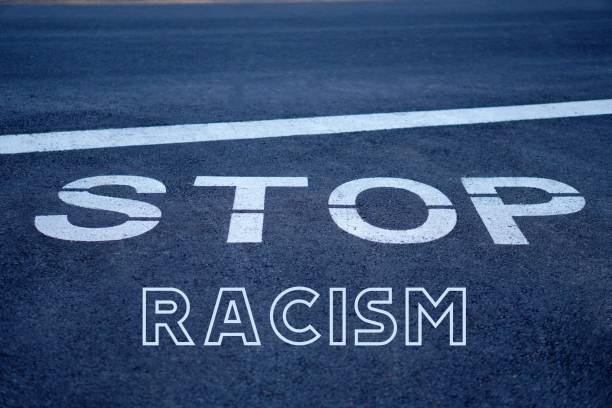 istock Stop racism concept. social issues. letters written on road signs. 2194855515