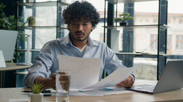 istock Focused businessman business person accountant office worker writing ideas in notebook paperwork Arabian Indian student write notes data information e-learning with laptop computer educational course 2194858312