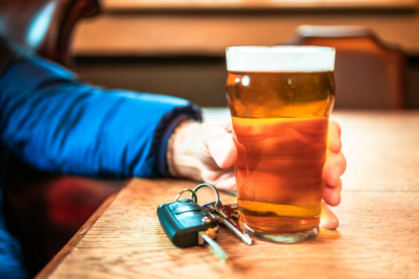 istock Man sitting in pub with beer and car keys, drunk driving concept 2194860073