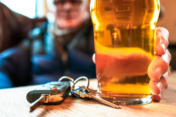 istock Man sitting in pub with beer and car keys, drunk driving concept 2194860184