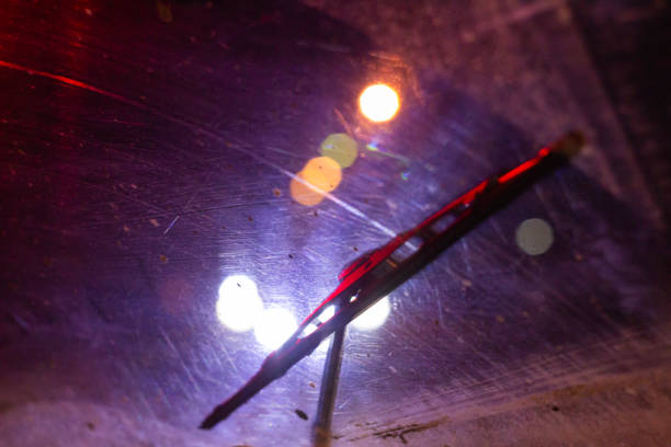rain drops on window surface with colorful traffic bokeh light in background