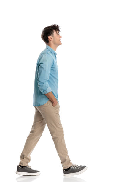 istock proud young student walking with hands in pockets and smiling 2194861626