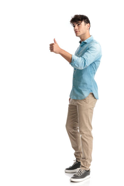 istock young man in his 20s in blue shirt making thumbs up gesture 2194861996
