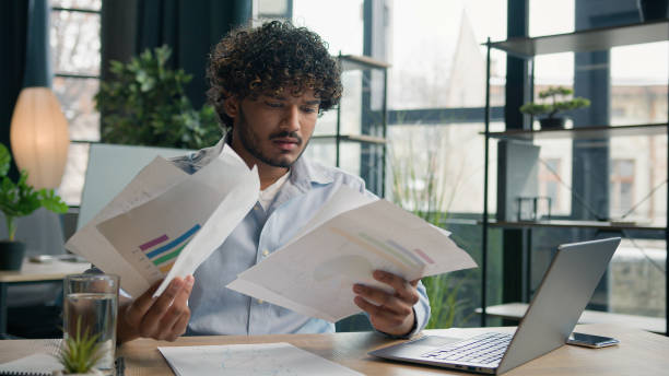 istock Mad stressed crazy Arabian Indian man in office failure work angry tired businessman problem with paperwork stress difficult task trouble throwing papers documents business mistake fatigued overwork 2194862041