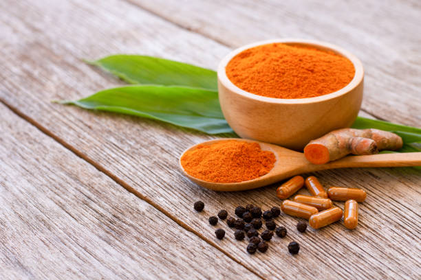 istock Turmeric capsules and turmeric powder with black peppercorns 2194862083