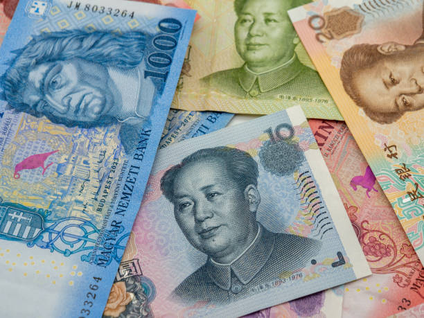 istock stack of Hungarian forint banknotes and Chinese yuan 2194863121