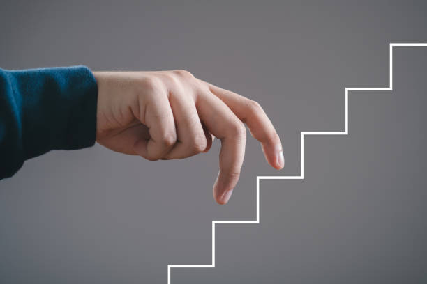 istock Fingers walking up drawn staircase concept, symbolizing progress, success, growth, ambition, and career development. 2194863258