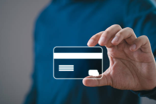 istock Man holding a blank credit card in a transparent floating UI interface, depicting modern digital and contactless payment technology. 2194863345