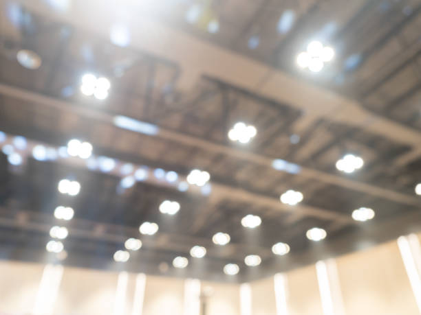istock Blurry auditorium scene background for advertising, business presentation. Abstract blur lighting decoration interior. Blurred convention hall construction building, ceiling spotlight soft unfocused. 2194864165