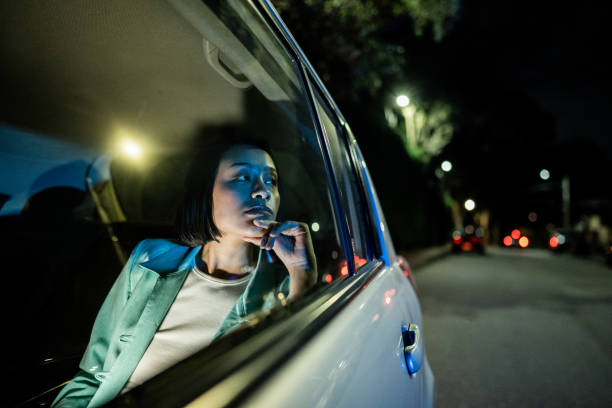 istock Businesswoman looking through the window inside the car 2194866979