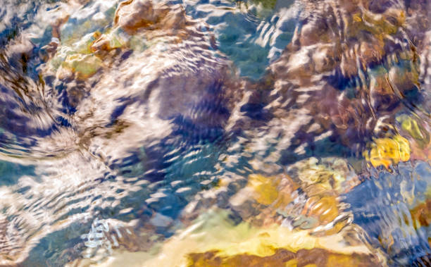 istock Abstract flowing water  background. Bright  water flow with stones and foam 2194867031