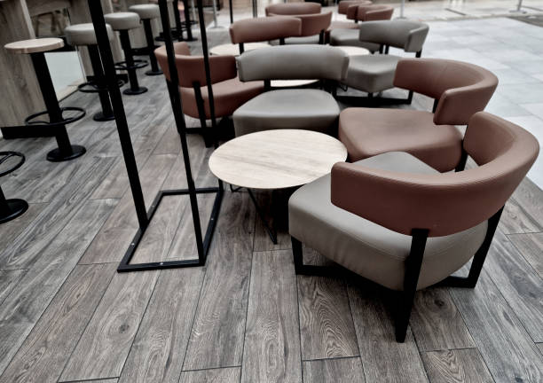 circle-shaped tables in the cafe with leather upholstery. brown curved chair backs