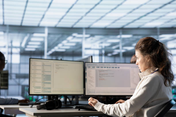 istock Woman in data center at PC checking servers bottlenecks leading to malfunctions 2194867338