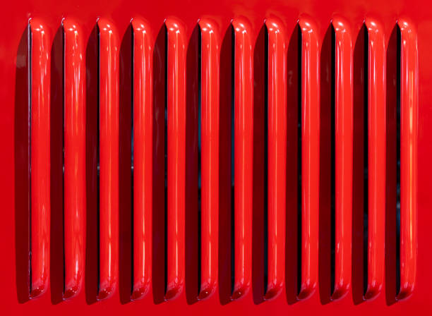 istock Red car grille with vertical slats closeup view 2194867495