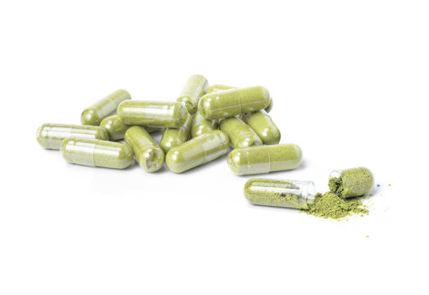 istock green herbal powder medicine capsules pill 2194869100