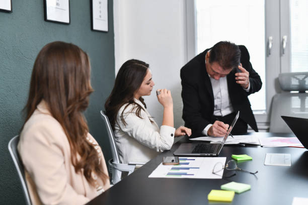 istock Female Looking Focused While Busy CEO Is Explaining and Examining Her Work and Talking on Phone 2194869994
