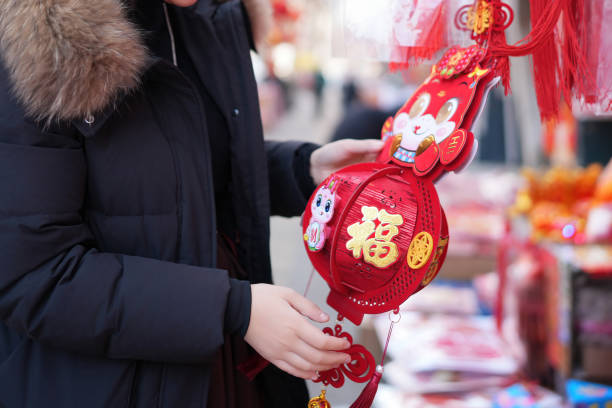 Celebrating Tradition: An Individual Selecting Decorative Lanterns for a Festival