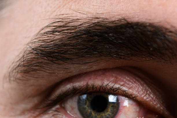 Close up on teenager boy's smiling eyes, green brown color