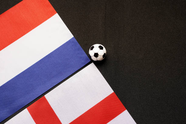 Soccer Ball on desk surrounded with many different flags from around the world in a classroom or office setting