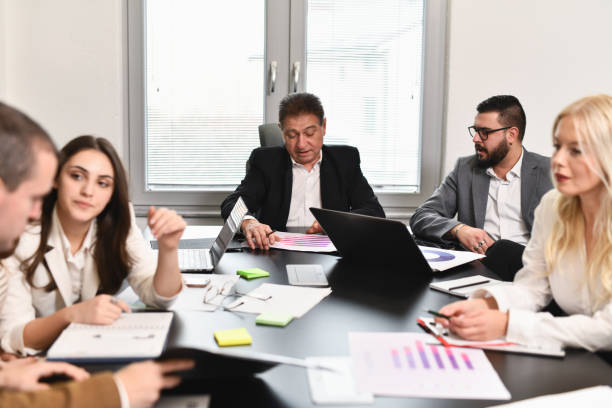 istock Diverse Group of Employees Analyzing and Examining Paperwork on Business Meeting 2194871193