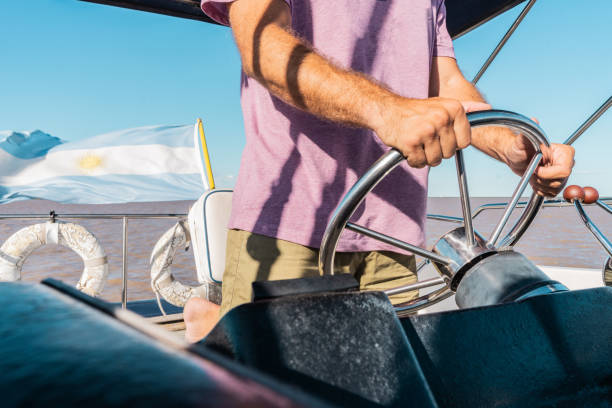 Close-up of a man piloting sailboat
