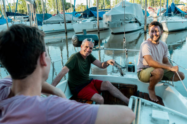 Father and son talking during travel by sailboat
