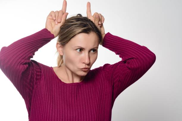 istock Woman making playful horns gesture. 2194871817