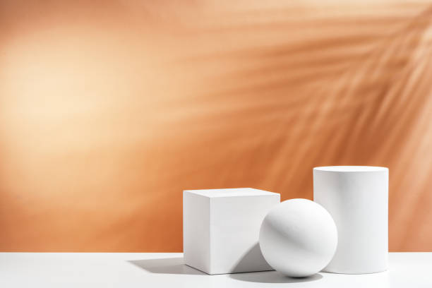 istock White geometric shapes arranged stylishly on a soft peach background in a minimalist setting 2194871874