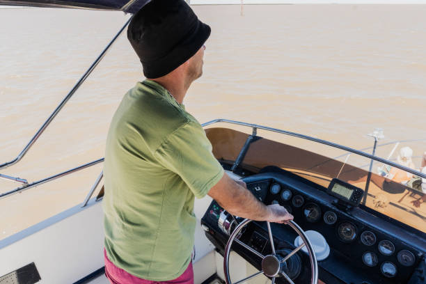 istock Mid adult man piloting sailboat 2194872768