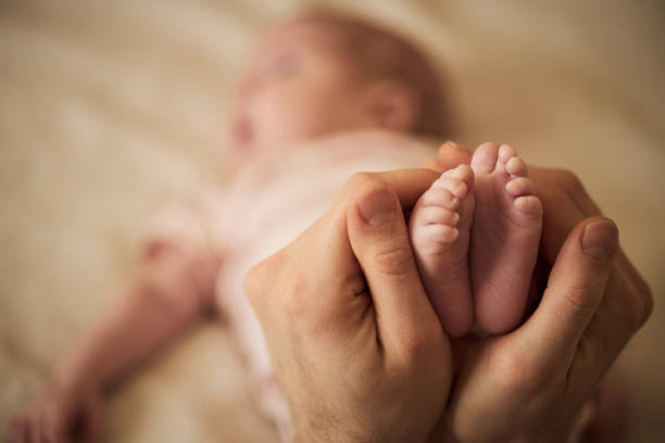 A baby's feet in parents hands