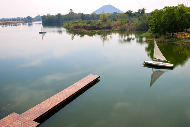 Boats sailing in a large pond