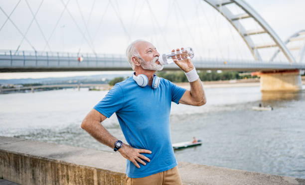 istock Senior man drinking water during workouts outdoors 2194873783