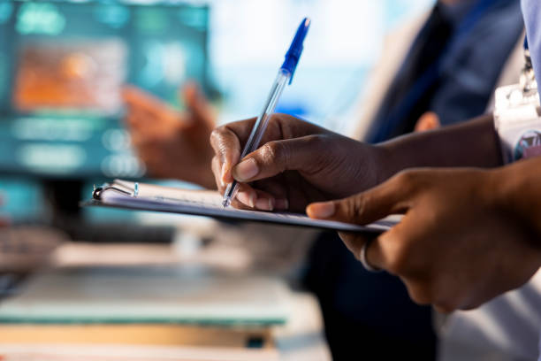 istock Medical assistant takes notes on hospital records files during checkup 2194873930