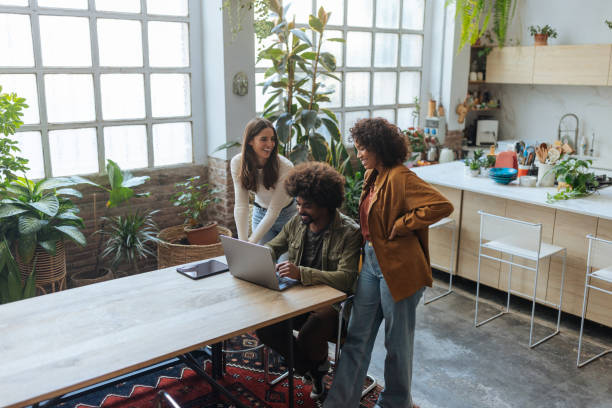istock Young professionals collaborating on laptop in modern office 2194875742