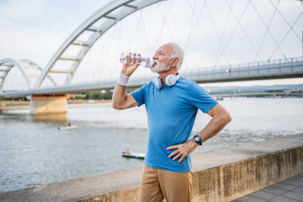 istock Senior man drinking water during workouts outdoors 2194875756