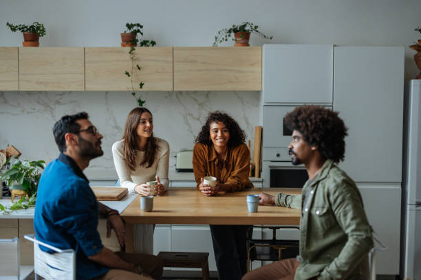 istock Young adults enjoying coffee break together in modern kitchen 2194875837