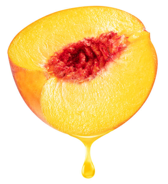 istock Slice of peach fruit and peach juice dripping from it on a white background. File includes clipping path. 2194876183