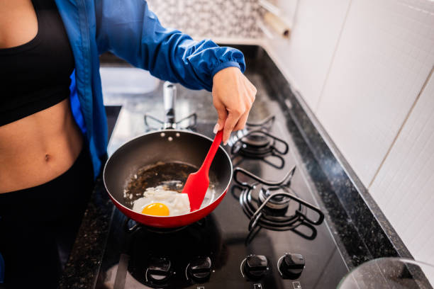 istock Woman cooking breakfast at home 2194876246