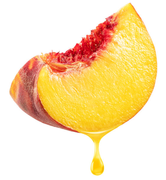 istock Slice of peach fruit and peach juice dripping from it on a white background. File includes clipping path. 2194876303