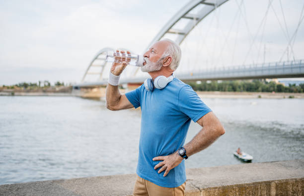 istock Senior man drinking water during workouts outdoors 2194877016