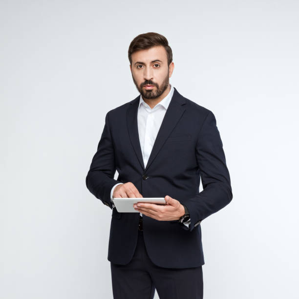 istock Portrait of confident businessman using digital tablet 2194877397