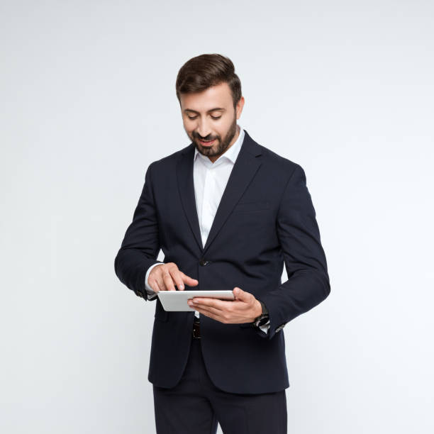 istock Portrait of pleased businessman using digital tablet 2194878071