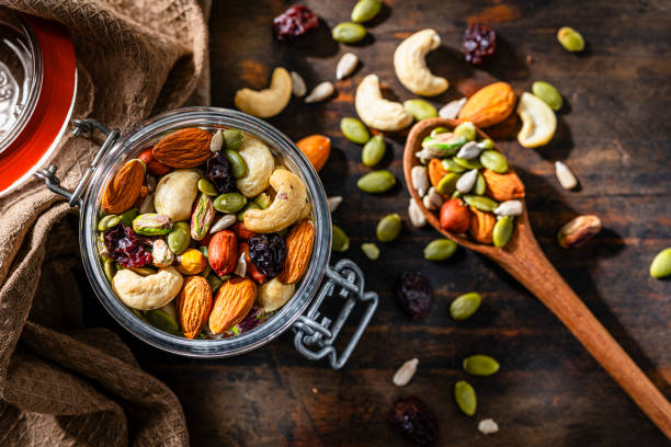 Mixed nuts and seeds in a glass container shot from above