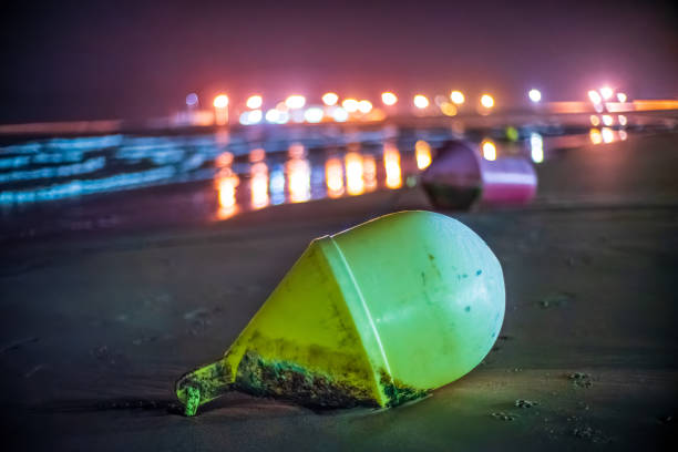 istock Illuminated Beach Buoys at Low Tide in Barbate at Night 2194878863